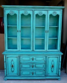 an old china cabinet painted in aqua blue