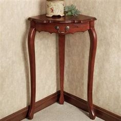 a small wooden table with a potted plant on top