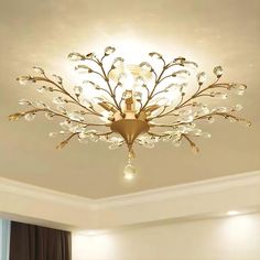 a fancy chandelier in the middle of a room with white walls and curtains