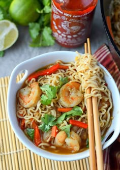 shrimp noodle soup in a white bowl with chopsticks