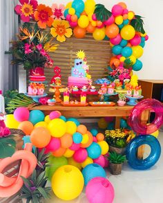 an assortment of colorful balloons and decorations for a birthday party