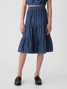 Soft denim midi skirt.  Elasticized waist.  Tiered skirt.  Responsibly Made: This denim skirt is part of our water-saving Washwell program.  Compared with conventional wash methods, Washwell uses at least 20% less water and has saved over a billion liters of water since 2016.  This product was made in a factory that invests in gender equality and women’s empowerment.  Through RISE Reimagining Industry to Support Equality) and Gap Inc. ’s program P. A. C. E.  Personal Advancement & Career Enhance Gap Kids, Support People, Denim Midi Skirt, Tier Skirt, Dress With Cardigan, Denim Skirt, Midi Skirt, Summer Outfits, Fashion Outfits