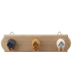 three small birds are perched on a wooden sign that is hanging from it's sides