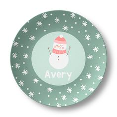 a green plate with a snowman on it and the word avery written in white