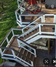 an aerial view of a deck with stairs and railings on the side of a house