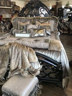 a bed with fur and pillows in a store