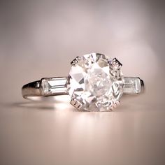 an old cut diamond ring with two baguets