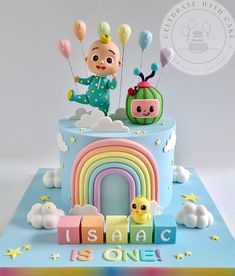 a birthday cake decorated with an image of a baby in the sky and rainbows