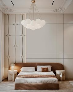 a bedroom with a large bed and chandelier hanging from the ceiling