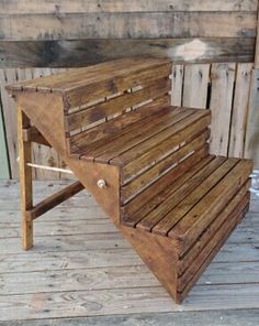 a wooden bench sitting on top of a wooden floor next to a wall with wood slats