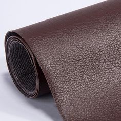 a brown leather tie on a white background