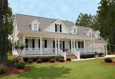 a large white house sitting on top of a lush green field