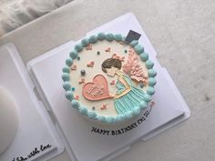 a birthday cake is decorated with an image of a woman holding a heart on it