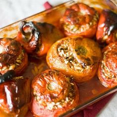 several stuffed peppers in a glass dish on a table