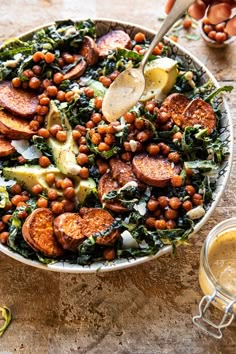 a bowl filled with beans, greens and potatoes