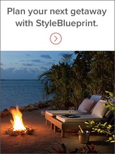 a fire pit sitting on top of a sandy beach next to the ocean at night