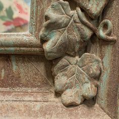 an old window frame with a leaf and acorn on it