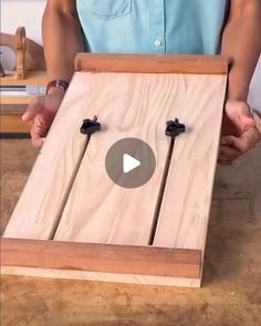 a person is holding a piece of wood with two screws on it and the video below shows how to make an easy diy project