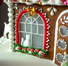 a decorated gingerbread house with white frosting