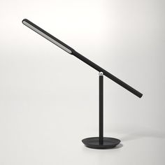 a black desk lamp on a white background