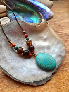 Stunning Handmade Oval Turquoise Pendant Necklace with Tortoiseshell&Turqouise bead surround. on Fine Brown Waxed Cord.Coconut button fastening with turquoise&coral chip finish..one of a kind Hanging Crystals Diy, Turquoise Pendant Necklace, Hanging Crystals, Diy Crystals, Coral Turquoise, Turquoise Pendant, Amber Glass, Turquoise Beads, Favorite Jewelry