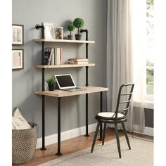 a laptop computer sitting on top of a wooden desk next to a wall mounted shelf