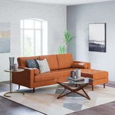 a living room with an orange couch and coffee table