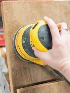 a person using a sander on a piece of wood