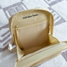 the inside of a white purse on top of a carpeted floor with words reading read more books