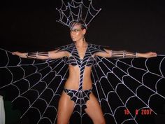 a woman in a costume with spider webs on it