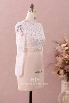 This designer bridal bolero is made out of beautiful flower lace and illusion tulle underneath, featuring exquisite scalloped lace trim adored along the boat neckline, long sleeve cuffs, edge of front bodice and the open back. It will match perfectly with bridal pantsuits and skirts in any silhouette. shown color light ivory bra support no boning no closure back button lining no lining Long Sleeve Lace Crop Top, Bridal Pantsuit, Bra Support, Bridal Bolero, Illusion Tulle, Light Ivory, Flower Lace, Lace Crop Tops, Support Bras