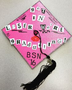 a pink graduation cap with words written on it and a tassel hanging from the side