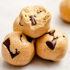 chocolate chip cookies stacked on top of each other with one broken cookie in the middle