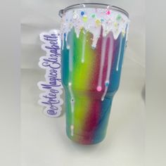 there is a cup that has been decorated with sprinkles