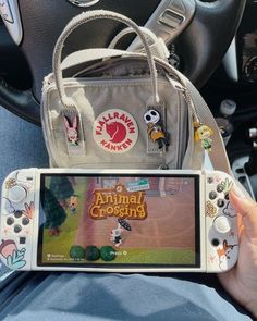 someone is holding an animal crossing game in their hand