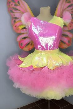 a pink and yellow dress with butterfly wings