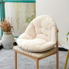 a chair sitting on top of a rug next to a window