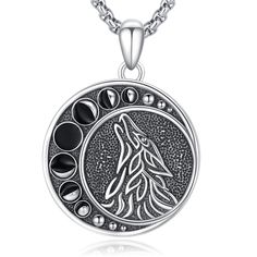 the wolf pendant is shown on a chain with black stones and silver beads around it