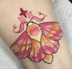 a tattoo with a pink and yellow butterfly on it's leg, next to a star