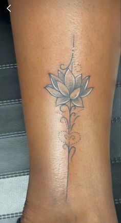 a woman's lower back tattoo with a flower on it