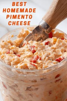 a glass jar filled with homemade pimentoo cheese and a wooden spoon in it