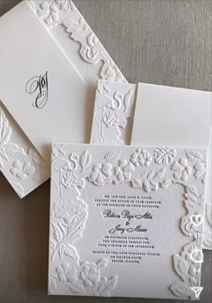 the wedding stationery is laid out on top of each other, with an elegant monogrammed design