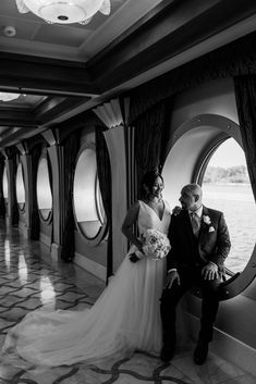 the bride and groom are posing for a photo in front of an oval window at their wedding reception