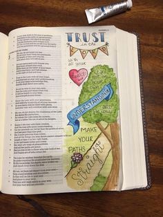 an open bible with the words trust on it and a marker next to it that says,