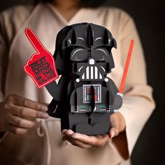 a person holding a darth vader origami box