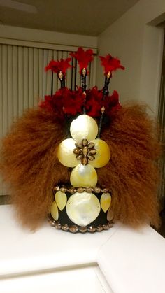 a vase filled with red and white flowers on top of a counter