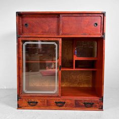 an old fashioned wooden cabinet with glass doors