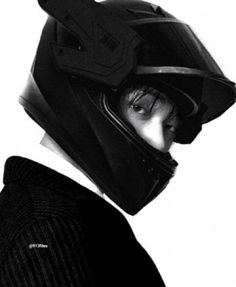 black and white photograph of a man wearing a motorcycle helmet with his face obscured by the visor