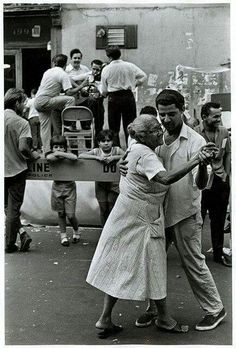 an old black and white photo of two people dancing