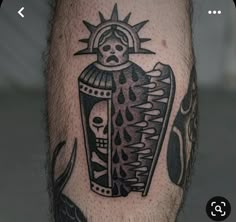 a man's leg with a tattoo on it and an image of a skull holding a bottle